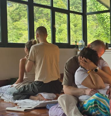 Participants holding each other during a sharing practice