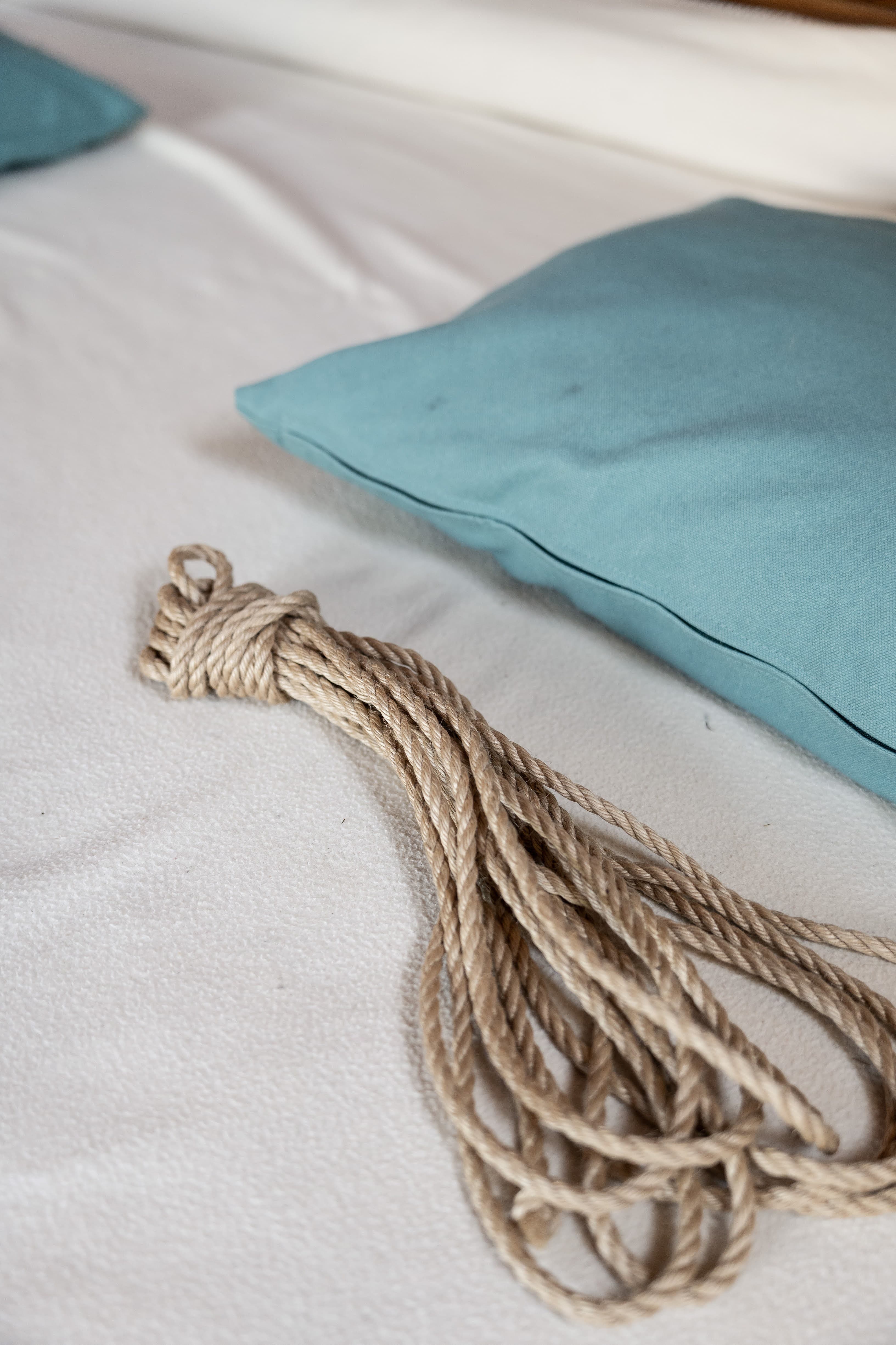 A bundle of rope beside a cushion